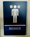 A restroom sign labeled "Beings", which appears to depict a 3-headed person. Can be considered dehumanizing to transgender/nonbinary people.